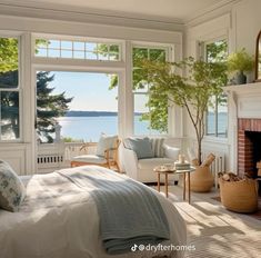 a bedroom with a fireplace and large windows