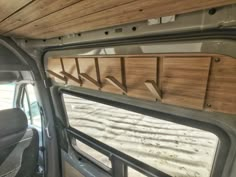 the interior of a vehicle with wood paneling and metal bars on the side window