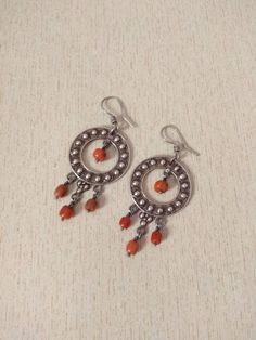 This is a beautiful vintage silver 925 earrings with old natural coral beads. These earrings are a circle with a coral bead hanging in the middle and 3 beads from the bottom These earrings have a good size and weight to be worn. Length : 8,5 cm (3,3 inches) Width : 3,5 cm (1,37 inches) Weight : 22 g Traditional Earrings With Round Natural Stones, Traditional Earrings With Natural Stones, Artisan Earrings With Dangling Beads, Gift Silver Beaded Round Earrings, Traditional Sterling Silver Earrings With Natural Stones, Handmade Red Coral Dangle Earrings, Traditional Round Earrings With Natural Stones, Artisan Sterling Silver Earrings With Dangling Beads, Old Silver Coins