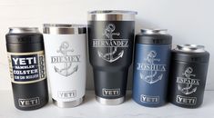 there are many different types of cups on the counter top, including one with an anchor