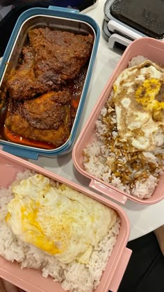 three pink trays filled with rice, meat and other food on top of a table