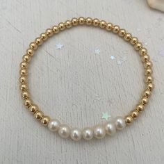 For the girls who love pearls, seven freshwater pearls on a golden strand are the epitome of a classic piece and any jewelry lovers must have! Sure to become your new favorite everyday staple. 4mm quality gold fill beads strung on super strong stretch cord accented 6mm pearls. A classic piece that you'll love and want to wear time and again. How to figure out your wrist size: use a soft measuring tap to measure your wrist. make sure to wrap the measuring tape around your wrist so that it makes c Pearl Strand, Rose Gold Chain, Handmade Wire Jewelry, Pearl Strands, Measuring Tape, Heart Beads, Bracelet Gold, Birthstone Necklace, Pretty Jewellery