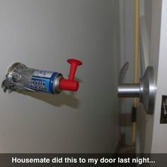 a door handle that is attached to a door with a spray bottle on it and the words housemate did this to my door last night