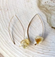 "Raw unpolished Citrine gemstone hoop threader earrings in your choice of sterling silver or 14kt gold filled. They're perfect for your everyday wardrobe or a night out on the town. Simple yet elegant. EARRING DETAILS: * Rough/Raw Unpolished Citrine Gemstones (size will vary. No two stones will be the same but I match them best I can.) * Real Sterling Silver (not plated) or 14kt Filled in standard 20 Gauge wire open threader hoops. * 1.75 in length. .3/4\" width * They will stay in your ears on Everyday Citrine Gemstone Jewelry, Teardrop Citrine Gemstone Jewelry, Amber Teardrop Pierced Jewelry, Adjustable Gemstone Hoop Jewelry, Minimalist Jewelry With Natural Stone Drop Earrings, Minimalist Natural Stone Drop Earrings, Adjustable Citrine Gemstone Jewelry, Amber Gemstone Drop Earrings, Adjustable Drop Earrings With Ear Wire