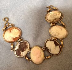 an antique bracelet with four pictures of women on it