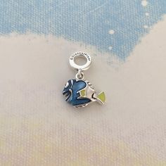 💖This sterling silver dangle charm features the much-loved forgetful fish brought to life with hand-applied enamel in transparent blue,yellow and black,with raised detailing on her fins and a characteristic sunny smile.Add this charm to your line-up as a reminder to stay focused on your goals - and never forget to look on the bright side! 💖Packaging:All the items are brand new,and will be sent in a clear plastic bag,put it into the box. 💖All the items are made from genuine 925 sterling silver,we highly appreciate a positive review if you are satisfied with our service. 💖Payment Option:You can pay with PayPal,but you don't have to have a PayPal account to make an order,you can simply pay with your credit card via PayPal checkout. 💖If your package doesn't arrive within the estimated del Blue Pendant Jewelry With Dangling Charms, Blue Jewelry With Removable Charms For Gift, Blue Jewelry With Removable Charms As A Gift, Blue Charm Bracelet With Dangling Charms As Gift, Silver Enamel Charms With Lobster Clasp, Blue Sterling Silver Charms For Gifts, Enamel Fish-shaped Jewelry For Gifts, Enamel Fish-shaped Jewelry As Gift, Nickel-free Blue Sterling Silver Charm Bracelet