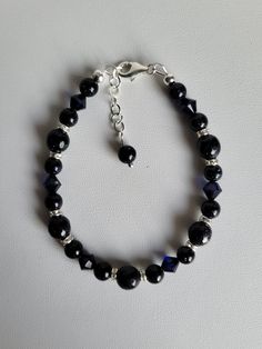 "This bracelet consists of Blue Sandstone gemstones, matching Swarovski crystal and sterling silver beads and findings. The bracelet has a 1\" extension with a beaded drop making it adjustable. These gemstones are a navy blue color with golden sparkles.  Custom Orders are always welcome! Ask about free sizing." Sterling Silver Crystal Bracelet With Round Gemstone Beads, Elegant Beaded Bracelets With Gemstone Czech Glass Beads, Elegant Faceted Czech Glass Bracelets, Adjustable Faceted Sterling Silver Crystal Bracelet, Elegant Faceted Czech Glass Bracelet, Elegant Czech Glass Beaded Bracelets With Gemstone, Adjustable Faceted Sapphire Bracelets, Elegant Czech Glass Gemstone Beaded Bracelets, Adjustable Faceted Sapphire Bracelet