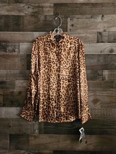 Vintage Cheetah or Leopard Print Blouse  *  Signature - Jones New York *  100% Silk Fabric  *  Label Size XL - See Measurements *  Tags Still Attached  *  New Condition *  Tan Brown Leopard Print 46"  Bust  44"  Mid Section - Waist Area 16"  Shoulders 26"  Length  24" Sleeve Length Very Nice Condition - No issues to disclose unless noted above - Ships Promptly and with care. Exact colors are not always easy to achieve in photos.  I try my best to describe accurately.  If you need to have a specific color or color match something, Please contact me for more information. Please keep in mind that this is a vintage item. It has been pre-loved & is likely not in perfect new condition but certainly wearable and ready to enjoy. Look at all photos carefully as they are part of the description. All Vintage Leopard, Printed Silk Blouses, Fabric Labels, Leopard Print Blouse, Brown Leopard, Label Sizes, Print Blouse, Jones New York, Tan Brown