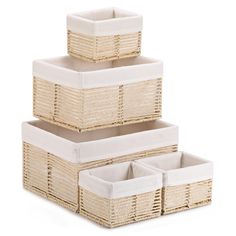 three wicker baskets stacked on top of each other with white linen lining the bottom