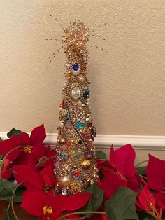 a christmas tree made out of jewelry and poinsettis