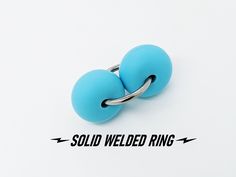 two blue balls are attached to a silver ring with the words sold weled ring below it