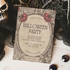 an old fashioned halloween party card with skulls on the table next to it and other decorations