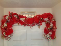 the door is decorated with red and white ribbons