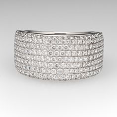 This sparkling wide band diamond ring is accented along the top half with two-hundred twenty-one (221), bead set, round brilliant cut diamonds. The ring measures 11.7mm at the top, rises 3.8mm above the finger, tapering to 5.7mm wide and 1.2mm thick at the base of the shank. The ring currently fits like a size 8. We are able to offer limited sizing on this one, please call with sizing questions. Wide Band Diamond Ring With Pave Setting, Wide Band Wedding Ring With Single Cut Diamonds, Luxury Wide Band Diamond White Diamond Ring, Modern Diamond Ring With Brilliant Cut And Wide Band, Diamond White Diamond Ring With Wide Band And Accents, Modern Wide Band Diamond Ring With Vvs Clarity, Modern Wide Band Diamond Ring With Brilliant Cut, Modern Brilliant Cut Wide Band Diamond Ring, Wide Band Diamond Ring With Brilliant Cut