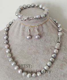 Welcome to my shop my dear friend. I hope you will like my jewelry, and most of my jewelry are made by myself. Please see the detail for this item: Pearl Jewelry: necklace set Pearl Type: baroque pearl Pearl Color: gray size: around 10-10.5mm Length: necklace: can choose, bracelet around 7.5-8 inch if you need other length, could contact me please! About shipping: I will send out your order in 1-3 business days from China. 1, To United States, will use US E-packet shipping service , usually will Silver Baroque Pearl Jewelry With Round Beads, Handmade Elegant Gray Jewelry, Handmade Gray Elegant Jewelry, Elegant Handmade Gray Jewelry, Gray Round Pearl Jewelry, White Pearl Bracelet, Length Necklace, Pearl Jewelry Necklace, Baroque Pearl Necklace