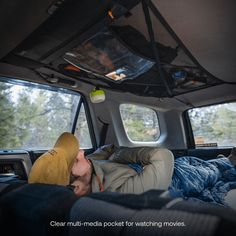 a man sleeping in the back of a truck