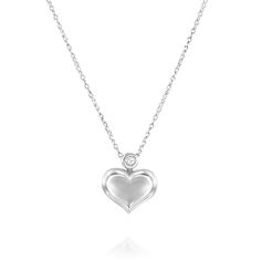 A heart cage pendant with a luxurious shine finish that includes elegant decorations on the other side combined with a brilliant round diamond. Romantic design suitable for any dress code. Materials:  White gold 18K. Carats: 0.20 Carats. Diamond cut: Round Brilliant. Colour: D-E-F  Clarity: VVS+ Heart proportions: Length: 10.60 mm. Width: 14.40 mm. Necklace thickness: 1.3mm Rolo diamond cut. - Purchase comes with a certificate of authenticity and valuation. For more information please contact us Luxury White Gold Heart Pendant Diamond Necklace, Luxury White Gold Heart Necklace With Diamond Cut, Luxury Silver Heart Pendant Diamond Necklace, Luxury Silver Diamond Heart Pendant Necklace, Silver Heart Pendant Luxury Diamond Necklace, Luxury Diamond White Necklace With Heart Charm, Luxury White Gold Double Heart Necklace, Luxury White Gold Heart Necklace With Brilliant Cut, Luxury Heart-shaped Single Diamond Jewelry