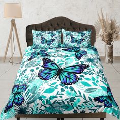 a bed with blue butterflies and green leaves on it