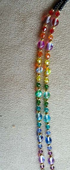 "This chain is done with all the beautiful colors of the rainbow. it is done with swarovski crystals and czech glass rainbow beads with goldplated spacer beads with black jet seed beads for the main chain, very beautiful look.it is approx 29\" long. if you would like a different length, email me right after buying or put it in the notes of paypal payment. it is strung on 49 strands of nylon coated wire, the strongest most flexible non kinking material available. check out my other listings as i Eyeglass Chain Holders, Glasses Chains, Black Jet, Rainbow Glass, New Glasses, Eyeglass Chain, Rainbow Beads, Eyeglass Holder, Glasses Chain