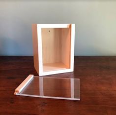 an empty shelf sitting on top of a wooden table