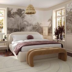 a bedroom with a large bed and wallpaper on the walls