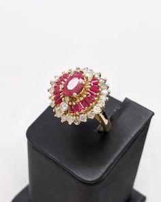 This ring is 14k yellow gold. The center ruby is an oval cut weighing 1.55 carats. The ring is accented with ruby baguettes. The total weight of ruby is 3 carats. The ring also has a diamond halo with two other diamond at the north and south ends of the ring. The total weight of diamond is 2 carats. This ring is a large statement piece that is sure to stand out. The face is 20 x 21mm. The piece weighs 6.3 dwt. Size 8, but can be resized up or down 2 sizes free of charge. Originally $5000, but is Ballerina Ring, Baguette Necklace, Ruby Bands, North And South, Turtle Pendant, Victorian Rings, Star Ruby, Antique Diamond, 3 Carat