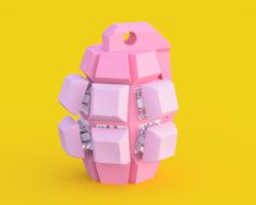 a pink object with lots of cubes attached to it on a yellow and orange background