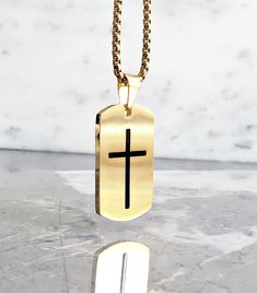 《《  THE PENDANT COLLECTION  》》 THE DETAILS The "GOLD CROSS TAG" Necklace is designed with an exquisitely detailed Matte Gold Stainless Steel Dog Tag Pendant, intricately engraved with a Black Cross, suspended from a Gold Stainless Steel Box Chain available in your choice of length!  💠🔶️💠View our entire PENDANT COLLECTION here: https://www.etsy.com/shop/MrMacKJewelry?ref=ss_profileFref§ion_id=30638859 MATERIALS * 1 1/4" × 3/4" Matte Gold Stainless Steel Black Cross Dog Tag Pendant  * 3mm Gold Gold Adjustable Chain Jewelry For Father's Day, Father's Day Gold Jewelry With Adjustable Chain, Gold Dog Tag Jewelry For Father's Day, Gold Dog Tag Necklace For Father's Day, Father's Day Gold Dog Tag Jewelry, Gold Cross Necklace For Father's Day, Necklace Length Chart, Dog Tag Pendant, Stainless Steel Chain Necklace