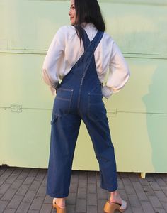 Vintage long dungarees in dark blue denim. Single front pocket. Front and back pockets. Size medium, UK 10-14 / EUR 38-42. Measurements - 9"(23cm) top of bib - 13"(33cm) bottom of bib - 32"(82cm) waist - 40"(102cm) hips - 27"(69cm) inner leg - 13.5"(35cm) rise. Material - Cotton & Modal mix. Condition - Excellent. Handpicked, repaired and ready to wear. This is an original vintage item, not new and minor signs of wear & age are expected, we will highlight any major flaws. Model is a UK 6/8 and is 5'7" tall. Blue Utility Overalls With Straight Leg, Blue Straight Leg Utility Overalls, Blue Utility Straight Leg Overalls, Medium Wash Bib Front Jeans For Work, Blue Bib Front Denim Jumpsuit With Pockets, Blue Denim Bib Front Jumpsuit With Pockets, Blue Denim Jumpsuit With Bib Front And Pockets, Denim Blue Bib Front Utility Jumpsuit, Utility Style Denim Blue Bib Front Jumpsuit