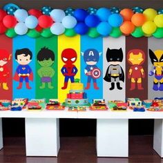 the table is decorated with superheros and balloons