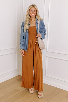 - Dare to let your style shine with this trendy jumpsuit! - Unlined material - A ruffled square cut neckline - A sleeveless cut with 1 inch spaghetti straps - Frayed accents - Functional side pockets - A relaxed silhouette that ends in straight hemlines Casual Spaghetti Strap Jumpsuits And Rompers With Smocked Back, Casual Wide Leg Jumpsuit With Smocked Bodice, Casual Fall Brunch Jumpsuits And Rompers, Trendy Brown Jumpsuits And Rompers For Spring, Trendy Brown Jumpsuits For Spring, Trendy Jumpsuit, Square Cut, Smocking, 1 Inch