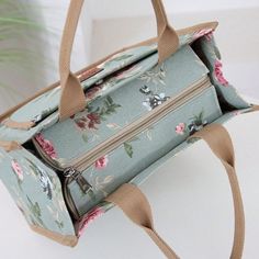 a blue floral bag sitting on top of a white table