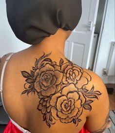 the back of a woman's shoulder with flowers on it