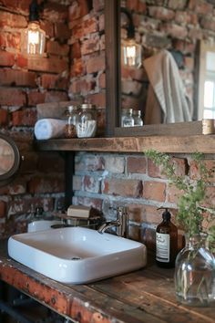 a bathroom sink sitting on top of a wooden counter next to a mirror and brick wall