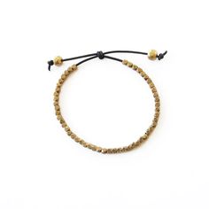 Faceted brass beads on black leather cord, adjustable slipknot closure. 6 inches around. Black or tan cord. Gold Beaded Bracelet With Adjustable Cord, Minimalist Gold Beaded Bracelets With Adjustable Length, Minimalist Gold Beaded Bracelet With Adjustable Length, Gold Beaded Bracelets With Adjustable Cord, Adjustable Gold Braided Bracelet With Round Beads, Adjustable Beaded Braided Bracelets For Everyday, Gold Metal Jewelry With Sliding Knot, Minimalist Gold Bracelet For Festivals, Handmade Adjustable Metal Braided Bracelets