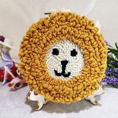 a crocheted lion coin purse sitting on top of a table