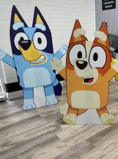 two cardboard cut outs of cartoon characters on the floor