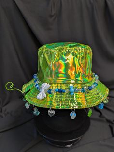 -hat color - green -bead color - blue -charm color - blue -unisex adult size -inner circumference - 22.5in -crown dip - 3in -brim - 2.25in -NOT machine washable -Perfect for raves and outdoor festivals! Shipping within the US USPS First Class Package 3-9 days USPS Priority Mail 1-5 days USPS Priority Mail Express 1-3 days Shipping International  USPS First Class Mail International  -Varies- USPS Priority Mail International 6-14 days USPS Priority Mail Express International 3-9 days Shipping times are estimated, NOT GUARENTEED.  +International buyers are responsible for all import fees+ +Orders of $50+ may require signature confirmation upon delivery+ Funky Adjustable Party Hats, Adjustable Blue Cap Costume Hats And Headpieces, Blue Adjustable Cap-style Costume Hats, Blue Bucket Hat For Festival, Blue Festival Bucket Hat, Blue Bucket Hat With Curved Brim For Festivals, Blue Curved Brim Bucket Hat For Festival, Blue Brimmed Bucket Hat For Festival, Blue Festival Hat, One Size Fits Most