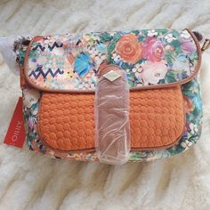 Nwt Oilily Medium-Size Shoulder Bag With Orange With Blush Floral Geometric Fabric. Front Pocket: Orange Fabric H: 6" X W: 8" Front Closure: Magnet Snap Inside Closure: Zipper Purse Size: H: 8.5" X W: 12" X D: 3" Strap: Adjustable Vegan Leather Orange Shoulder Bag With Adjustable Strap For Spring, Orange Shoulder Bag For Everyday Spring Use, Spring Bohemian Orange Bag, Spring Orange Crossbody Bag, Chic Orange Shoulder Bag With Zipper Closure, Bohemian Orange Pouch Shoulder Bag, Rectangular Orange Shoulder Bag With Gold-tone Hardware, Orange Shoulder Bag With Gold-tone Hardware, Floral Clutches