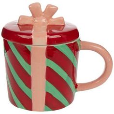 a red and green striped coffee mug with a bow on the top, sitting in front of a white background