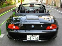 a black convertible car parked on the street