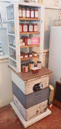 an old wooden cabinet filled with jars and jams