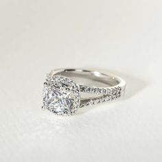 a cushion cut diamond ring with pave set shoulders