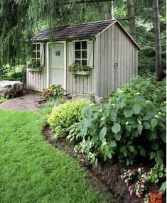 a small shed in the middle of a garden