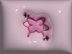 a pink object with stars on it in the shape of a butterfly, against a white background