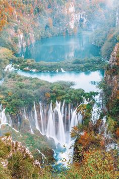 the waterfalls are surrounded by trees and foggy water in this beautiful landscape photo taken on an autumn day