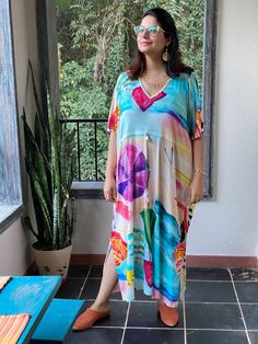 "This is our \"Timeless\" style kaftan. It features a drawstring that you can cinch at the waist. This loose fitting Caftan House dress is exceptionally comfortable and stylish. I created a short video about this style https://youtu.be/GDo-9c5XItk As for the fabric pattern, we have used a hand drawn and digitally painted technique. So they are all unique designs. It is like wearing wearable art. What I love about digital paintings is that they look as beautiful as the hand paintings but the care Casual V-neck Kaftan For Daywear, Multicolor Relaxed Fit V-neck Dress, Printed Multicolor Dresses For Loungewear, Multicolor Printed Dresses For Loungewear, Casual Multicolor V-neck Tunic, Multicolor Drawstring Dress For Vacation, Casual V-neck Relaxed Fit Kaftan, Multicolor V-neck Kaftan For Loungewear, Multicolor Rayon Kaftan For Spring