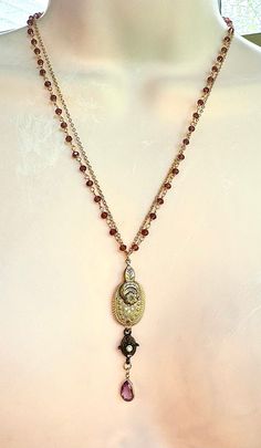 I made this Victorian, garnet rosary chain, brass stampings, amethyst, gold whimsical necklace. It is a mix of lots of wonderful vintage elements. It measures 20", but also has a generous extender. Artisan Gold Necklace From Vintage Collection, Antique Gold Spiritual Necklace With Vintage Charm, Artisan Gold Necklace For Vintage Collection, Spiritual Gold Necklace With Vintage Charm, Bronze Spiritual Necklaces For Vintage Collection, Garnet Rosary, Lavalier Necklace, Whimsical Necklace, Vintage Elements