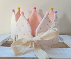 three little princess crowns with bows on them