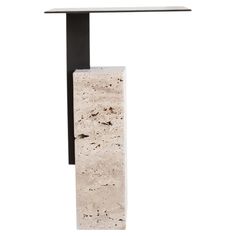 a white table with a black metal base and a marble slab in the shape of a rectangle